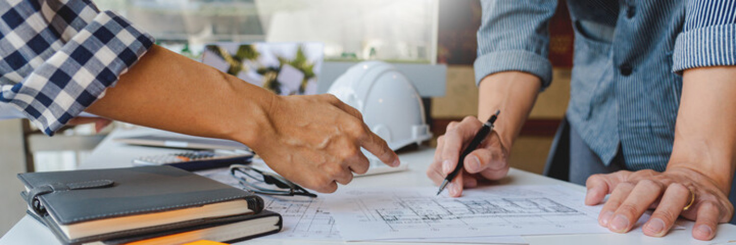 Contractors reviewing blueprints for a commercial construction project