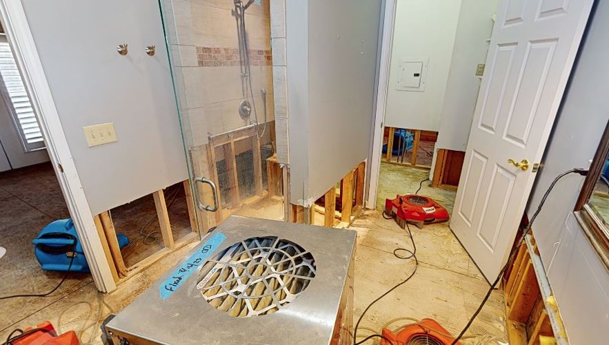 Active water extraction and drying equipment set up in bathroom restoration project