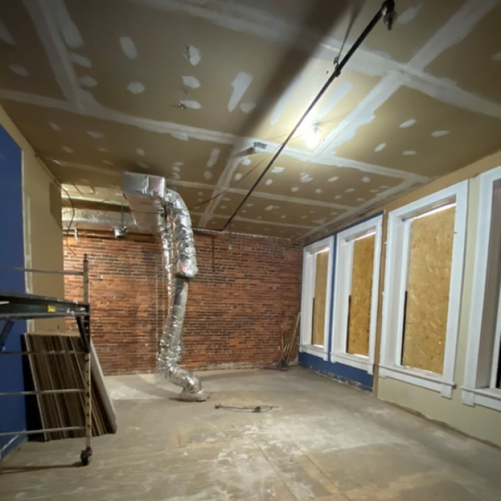 Interior under renovation with exposed framing and insulation during reconstruction
