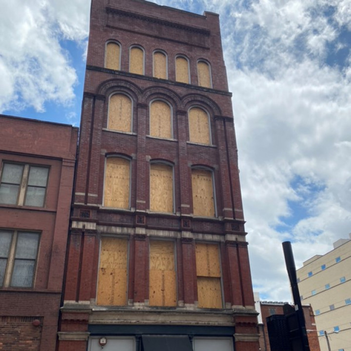 Downtown commercial brick building exterior showing multi-story property restoration site